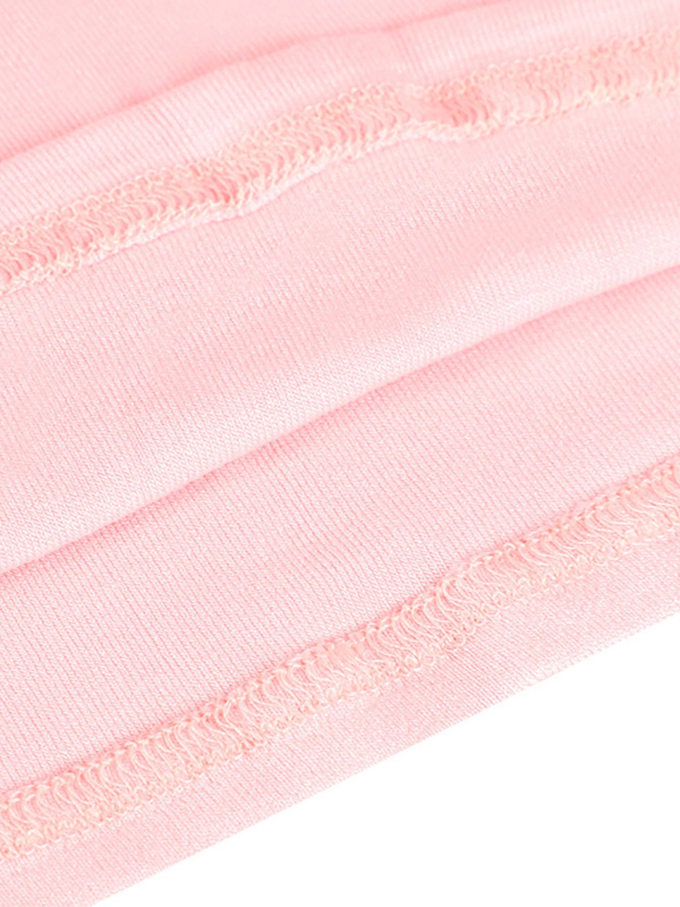 Close-up of pink ribbons with a white background