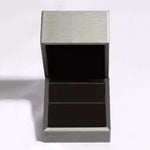 Metallic gray rectangular box with a lid on a white background
