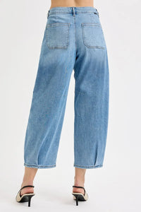 Light blue jeans worn by a person on a white background