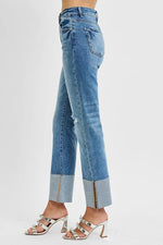 Blue jeans with a distressed effect on a white background