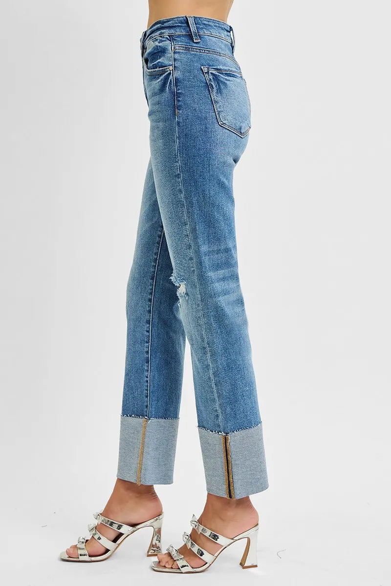 Blue jeans with a distressed effect on a white background