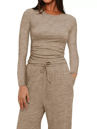 Beige long-sleeve top and pants set on a white background