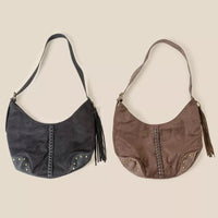 Two handbags, one black and one brown, on a beige background