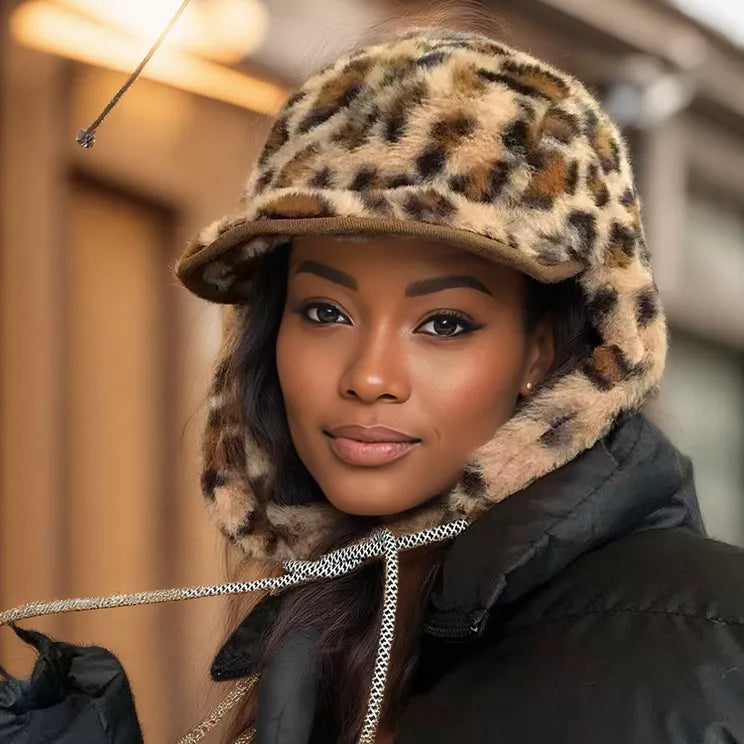 Woman wearing a leopard print hooded jacket with a blurred indoor background