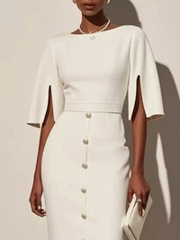 White dress with cape sleeves worn by a model against a neutral background