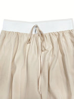 Beige pants with a white waistband on a white background