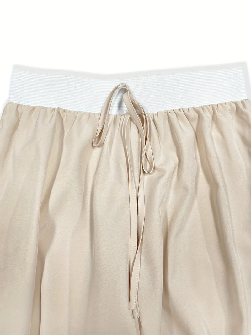 Beige pants with a white waistband on a white background