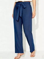 Navy blue pants with a tie waist on a white background