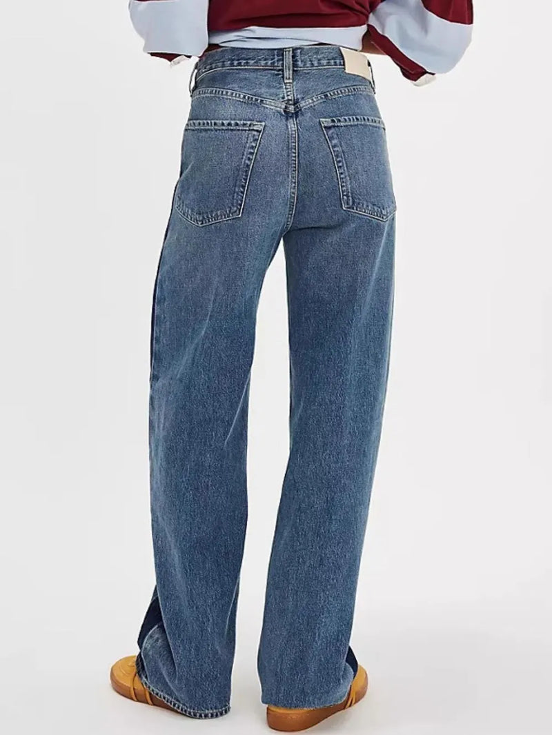 Blue jeans worn by a person on a white background