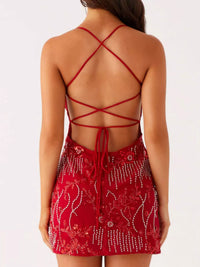 Red dress with intricate back design on a white background