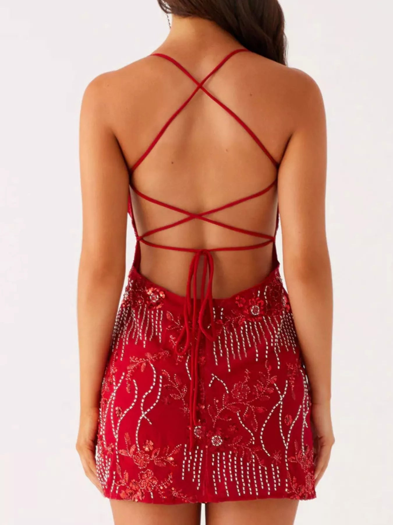 Red dress with intricate back design on a white background