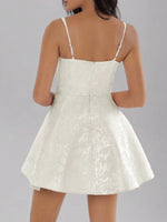 White lace dress on a plain background