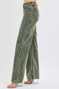Green acid-wash jeans worn by a person on a white background