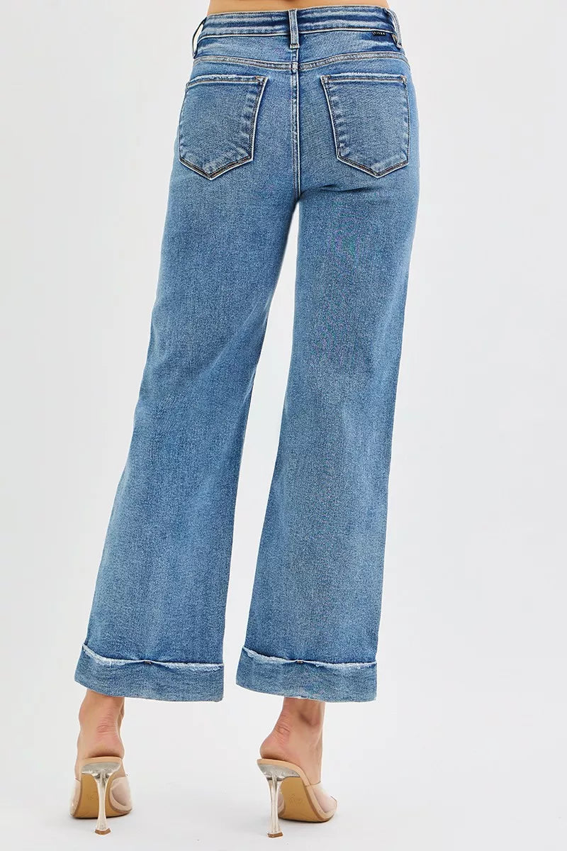 Blue jeans worn by a person on a white background