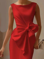 Red dress with a large bow detail on a neutral background