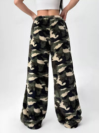 Camouflage patterned pants worn by a person on a white background