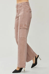 Pink cargo pants worn with black high-heeled shoes on a light gray background
