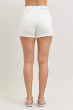 White shorts worn by a person on a plain background