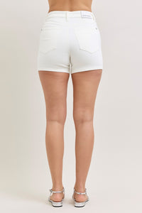 White shorts worn by a person on a plain background