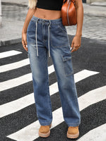 Person wearing blue jeans and brown shoes on a zebra crossing