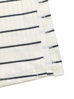 Close-up of a white fabric with black stripes on a white background