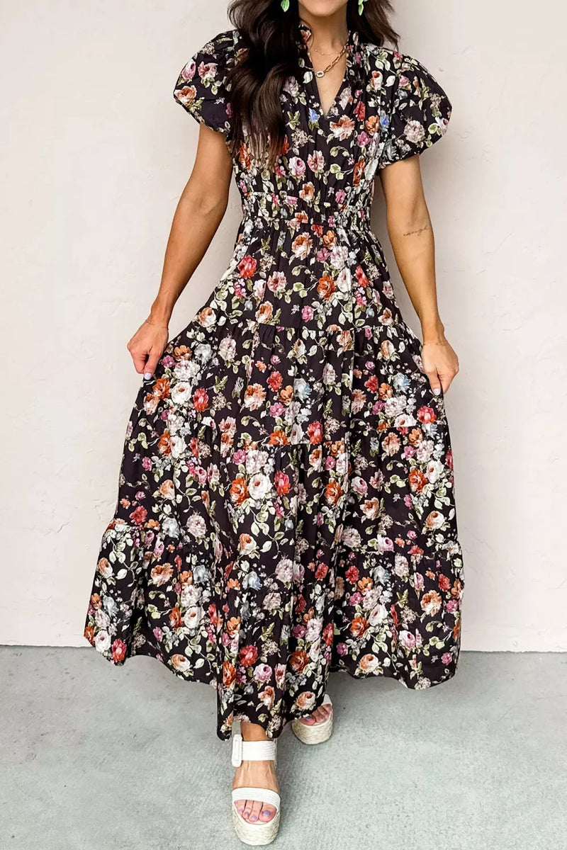Woman wearing a floral dress against a plain background