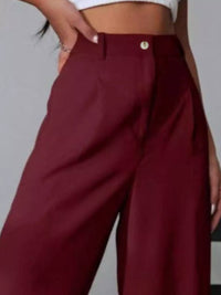 Maroon wide-leg pants worn by a person on a plain background