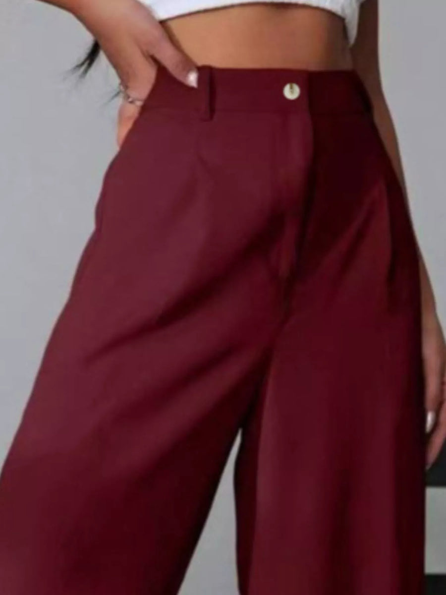 Maroon wide-leg pants worn by a person on a plain background
