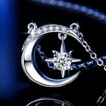 Silver necklace with moon and star pendant on a dark background