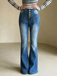 Person wearing a striped long-sleeve top and blue flared jeans on a neutral background