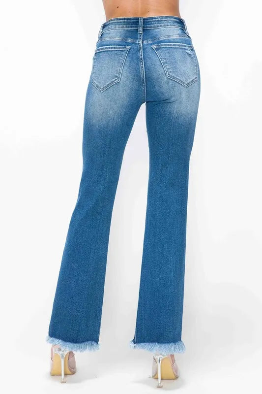Blue jeans with a frayed hem on a white background