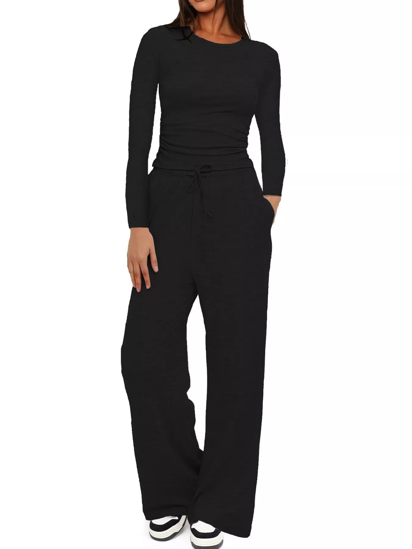 Black jumpsuit worn by a person on a white background
