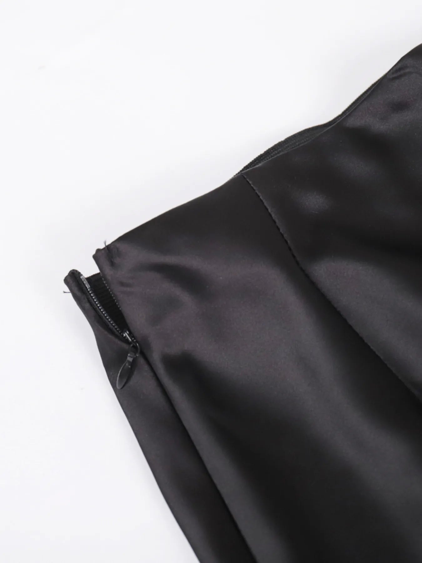 Close-up of a black jacket with a zipper on a white background