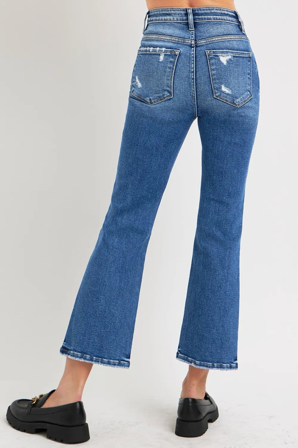Blue jeans worn by a person on a white background