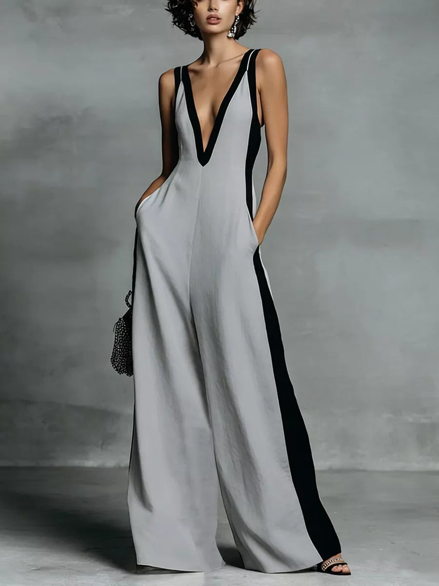 Woman wearing a gray and black dress against a gray background