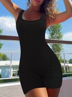 Woman wearing a black sleeveless romper with a scenic background