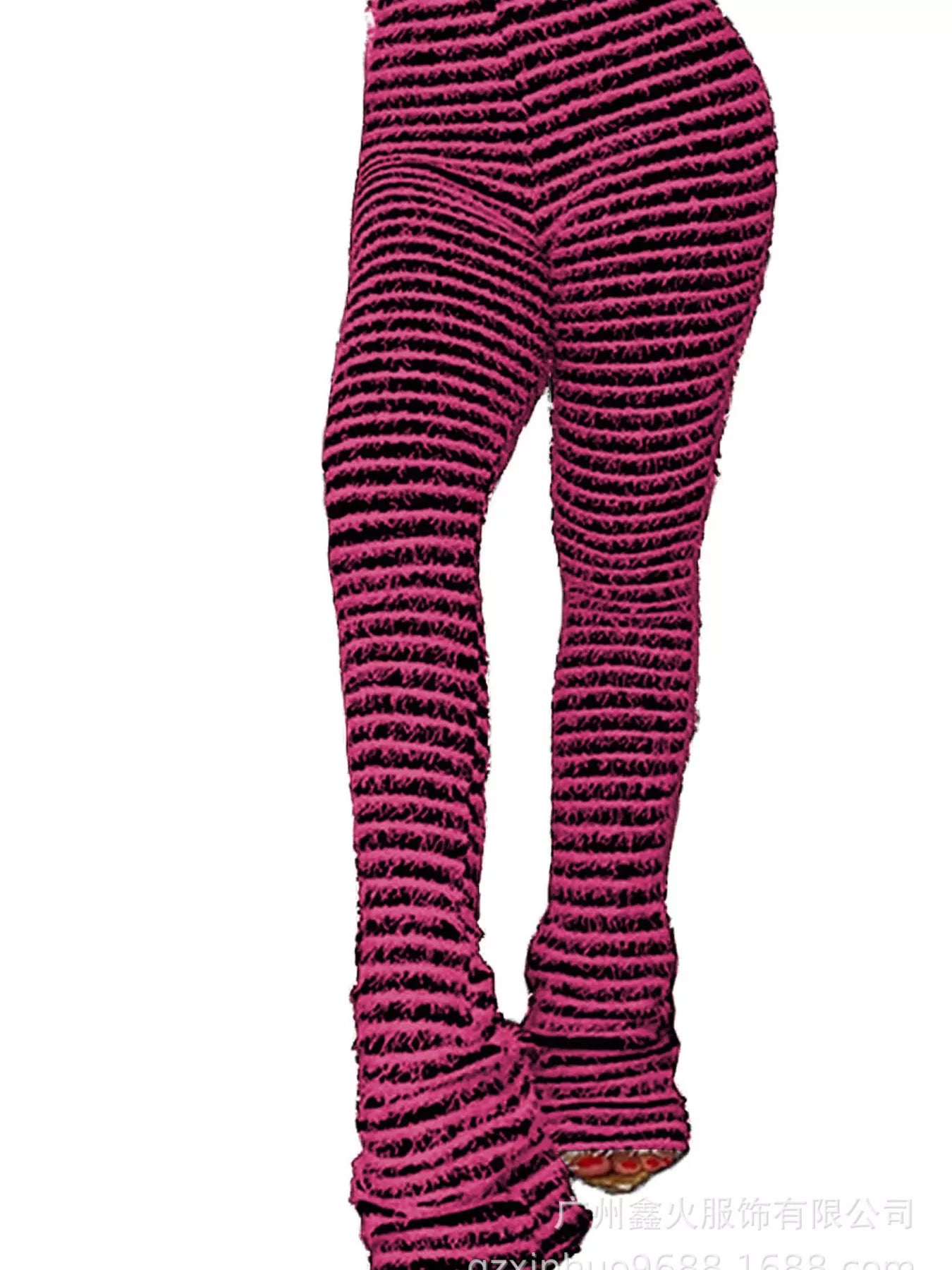 A close-up side view of a person wearing textured, ribbed knit leggings in a dark pink and black striped pattern, cropped from the waist down against a plain white background.