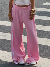 Person wearing pink sweatpants on a zebra crossing