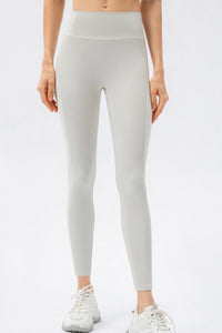 Light gray leggings worn by a person on a white background