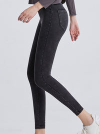 Black jeans worn by a person on a light gray background