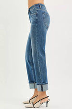 Blue jeans worn by a person on a white background