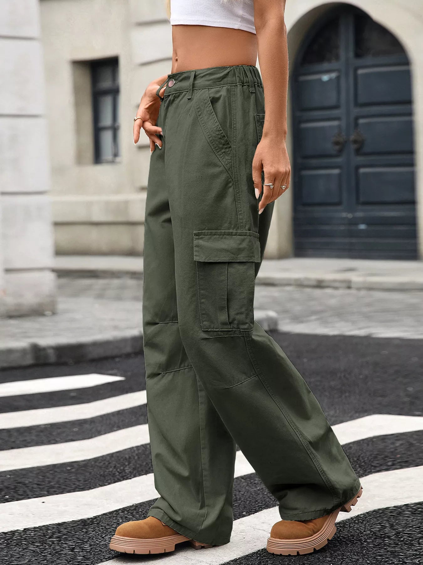 Person wearing green cargo pants on a city street