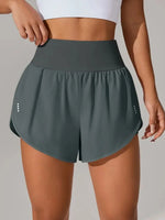 Person wearing dark green athletic shorts on a plain background