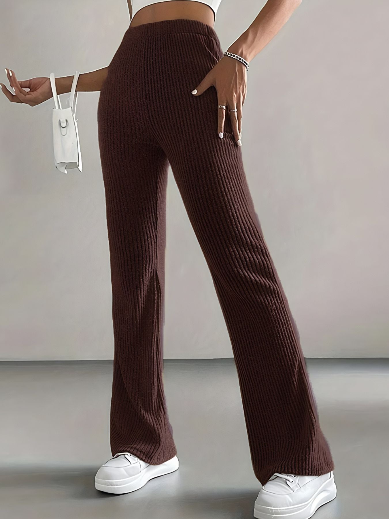 Brown ribbed pants worn by a person on a plain background