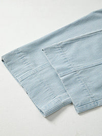 Folded light blue towel on a white background