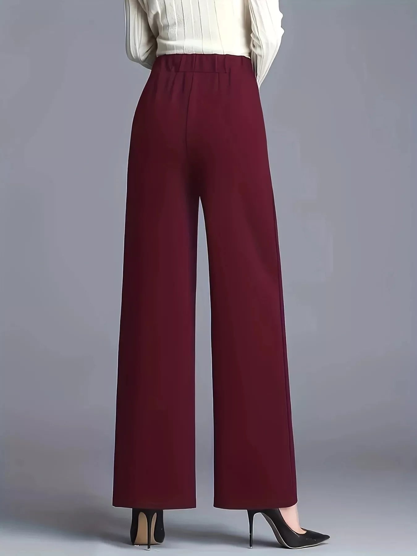 Maroon wide-leg pants worn by a person on a gray background