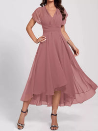 Woman wearing a pink dress on a white background