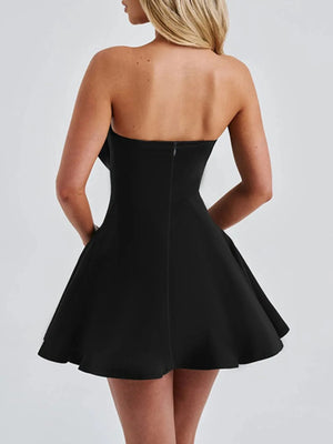 Black strapless dress with a plain background