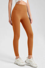 Person wearing orange leggings with a white background