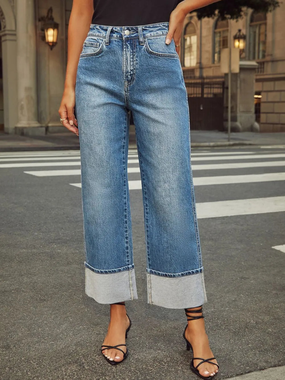 Person wearing blue jeans on a city street